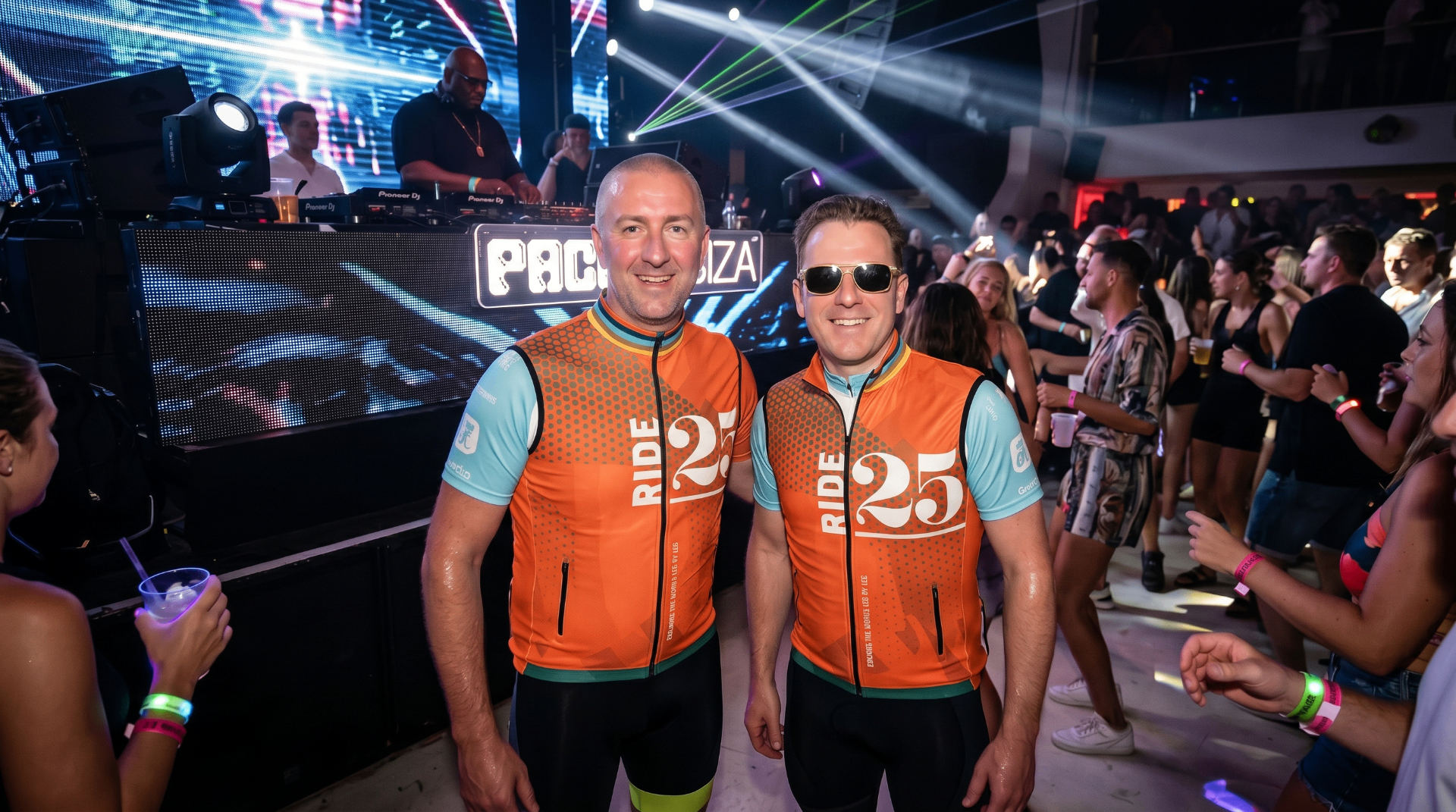 Ride25 riders in orange gilets at Pacha nightclub in Ibiza with a DJ behind