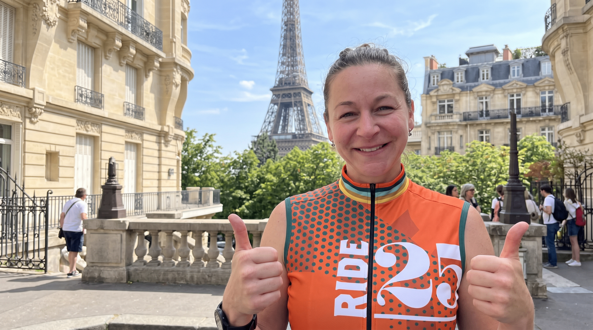 Ride25 rider giving thumbs up in front of the Eiffel Tower in Paris